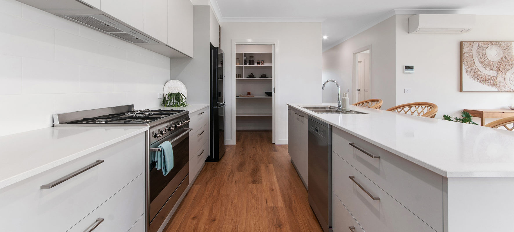 Photo of white kitchen with timber floor