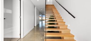 Photo of modern timber staircase and polished concrete floor