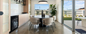 Photo of a modern dining area in a new home with round dining table and large window behind the table