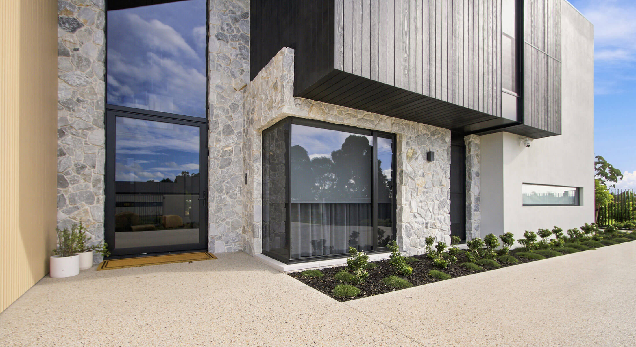 Contemporary Virtue Homes house with stone and timber facade